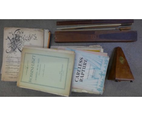 A French Maelzel Paquet metronome, four conductor's batons and a box of sheet music
