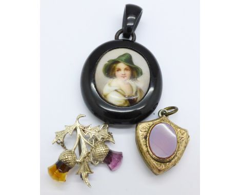 An oval jet memorial pendant with half portrait of a continental girl, a silver thistle brooch and a shield shape gilt metal 