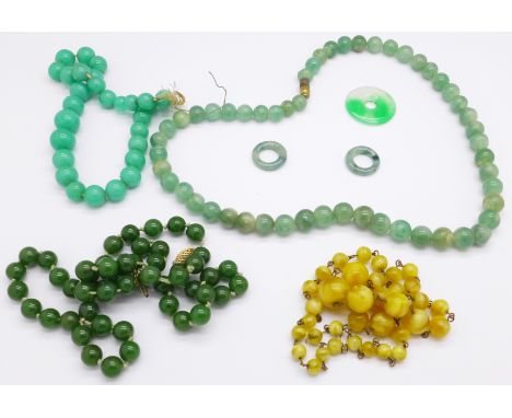 A dark green jade necklace, two other necklaces, etc.