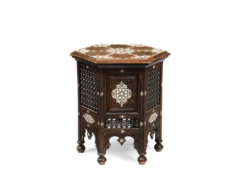  ANGLO-MORESQUE OCCASIONAL TABLE, CIRCA 1890 carved hardwood, inlaid with mother-of-pearl, and set with mashrabiya panels 44.