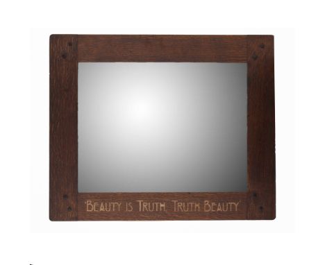  LIBERTY & CO., LONDON ARTS & CRAFTS WALL MIRROR, CIRCA 1910 oak, with mirror plate, inlaid with inscription BEAUTY IS TRUTH,