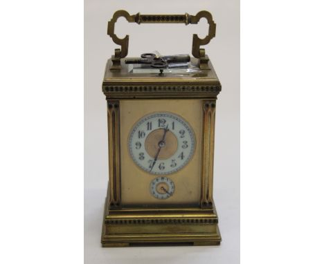 A French brass cased carriage clock, the movement having a lever platform escapement striking on a gong and featuring an alar