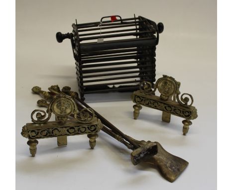 A metal concertina fire escape ladder, a pair of Regency style fire dogs and four hearth tools