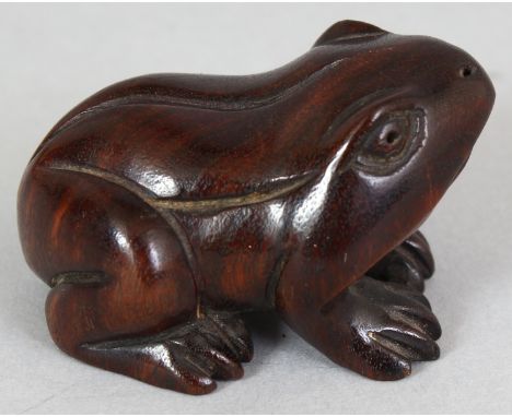 A JAPANESE CARVED WOOD NETSUKE OF A FROG, unsigned, 1.75in long & 1in high.