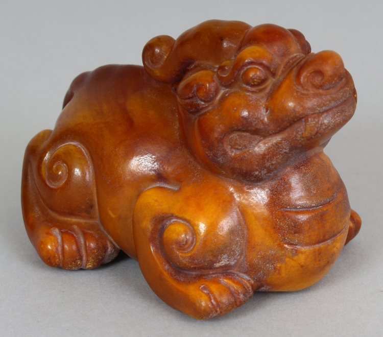 A CHINESE HORN CARVING OF A MYTHICAL ANIMAL, 3.4in long & 2.5in high.