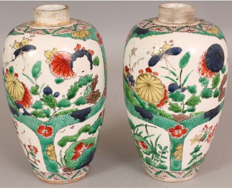 A PAIR OF FAMILLE VERTE PORCELAIN VASES, painted in a Kangxi style with panels of seasonal foliage, each short neck unglazed,