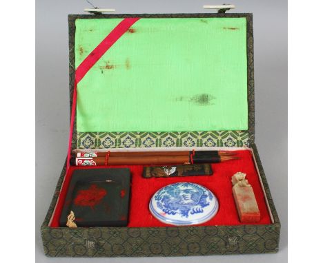 A 20TH CENTURY CHINESE CASED WRITING SET, contained in a fitted box, and comprising brushes, ink stones, a seal and a circula