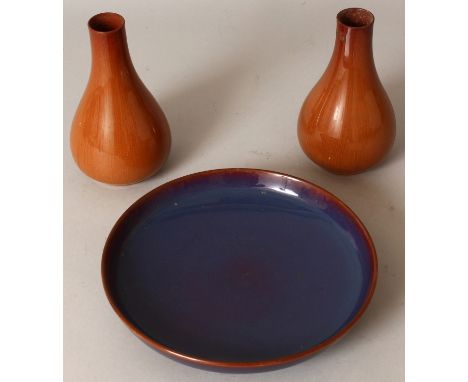 A CHINESE FLAMBE STYLE CERAMIC DISH, 8in diameter; together with a pair of brown glazed pear-form vases, 5.75in high. (3)