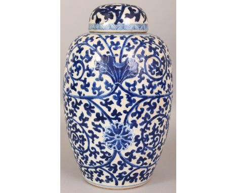 A 19TH CENTURY CHINESE BLUE & WHITE CRACKLEGLAZE PORCELAIN JAR & COVER, painted with an overall design of formal scrolling lo