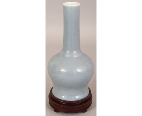 A CHINESE CLAIRE-DE-LUNE PORCELAIN VASE, together with a fitted wood stand, the sides applied with a pale slightly mottled gl