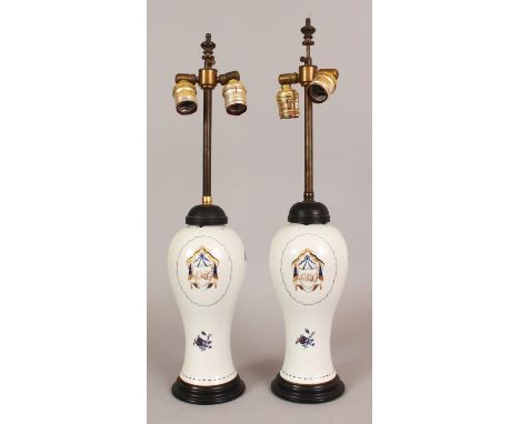 A PAIR OF CHINESE MONOGRAMMED PORCELAIN VASES, circa 1800, fitted for electricity, the sides of each baluster form body paint