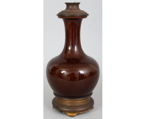 A CHINESE BROWN GLAZED PORCELAIN BOTTLE VASE, fitted as a lamp with late 19th Century French metal fittings, 12.5in high.