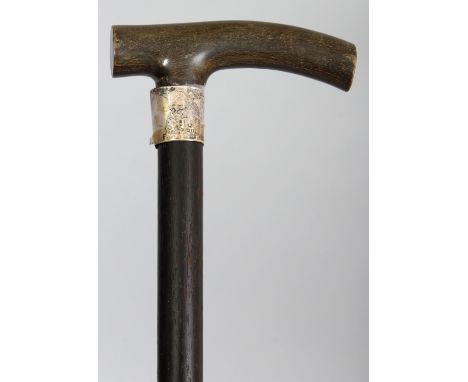 ANOTHER RHINOCEROS HORN HANDLED WOOD WALKING STICK, with a hallmarked silver collar bearing a presentation inscription, the r