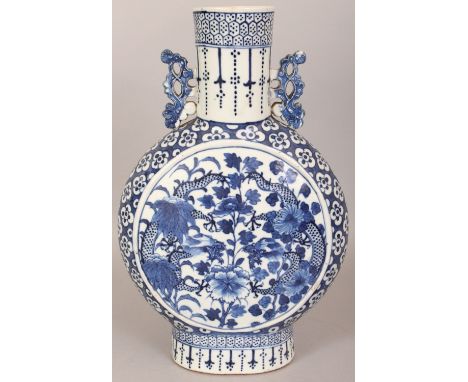 A 19TH CENTURY CHINESE BLUE & WHITE PORCELAIN MOON FLASK, each side painted with a circular panel of confronting dragons and 