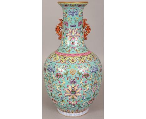 A CHINESE FAMILLE ROSE TURQUOISE GROUND PORCELAIN VASE, decorated with formal arrangements of scrolling lotus, bats and hangi