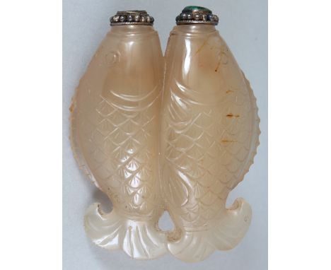 A CHINESE JADE DOUBLE SNUFF BOTTLE, with stoppers, the jade carved in the form of twin fish, 2in wide & 2.7in high.