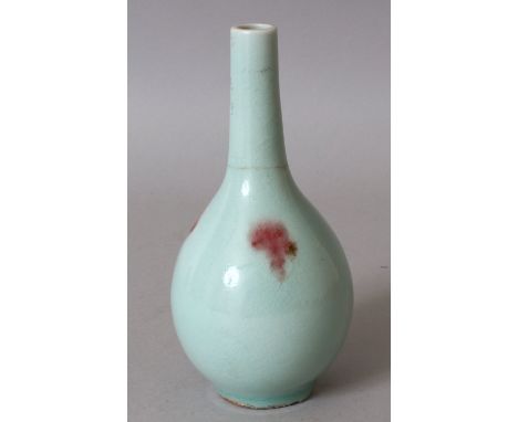 A 19TH CENTURY CHINESE JUNYAO STYLE PORCELAIN BOTTLE VASE, the sides with copper-red splashes over a pale celadon ground, the