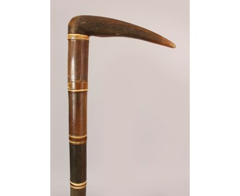 A GOOD RHINOCEROS HORN WALKING STICK, with rhino handle and rhino stick sections, the sections with narrow bone dividers, eac