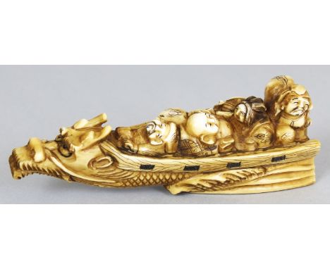 A SIGNED JAPANESE MEIJI PERIOD STAINED IVORY NETSUKE OF THE SEVEN LUCKY GODS, borne above waves in a narrow dragon-prowed riv