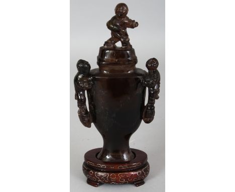 A CHINESE SMOKY QUARTZ VASE & COVER, together with a fitted wire inlaid stand, the vase with twin boy handles, the cover with