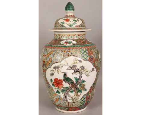 A LARGE 19TH CENTURY CHINESE FAMILLE VERTE PORCELAIN VASE & COVER, the sides painted with two large barbed quatrefoil panels 