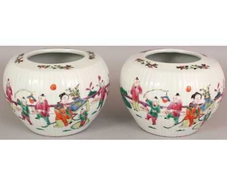 A PAIR OF CHINESE FAMILLE ROSE FLUTED PORCELAIN JARS, each decorated with a scene of ladies and playing boys in a fenced gard