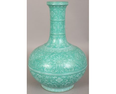 AN UNUSUAL CHINESE LIME GREEN GROUND PORCELAIN BOTTLE VASE, decorated in white slip with Shou characters and formal scrolling