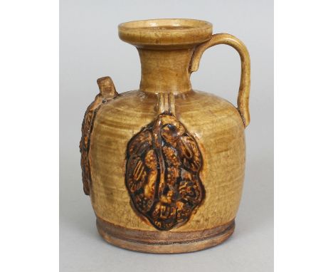A CHINESE TANG STYLE CHANGSHA CERAMIC EWER, with moulded decoration, 5.25in high.