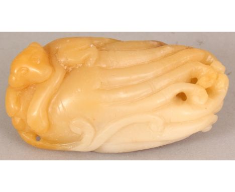 AN UNUSUAL CHINESE JADE CARVING, modelled in the form of a monkey clasping a finger citron, the stone of white and brown hues