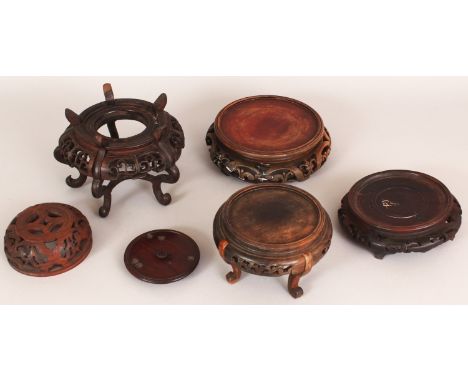 A GROUP OF FIVE 19TH/20TH CENTURY CHINESE WOOD STANDS & A WOOD JAR COVER, the largest stand 7.1in diameter, the jar cover 4.1