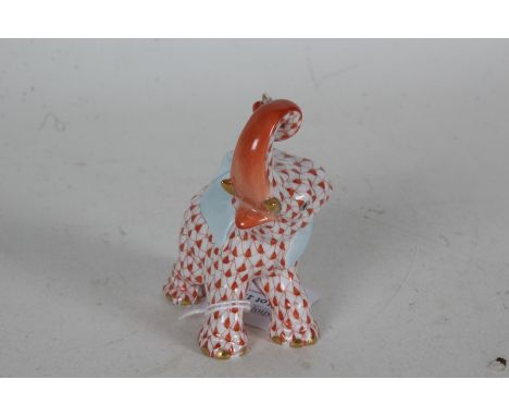 Herend porcelain figure depicting an elephant with trunk raised, with red scale decoration, incised 5266 to base, 9cm high