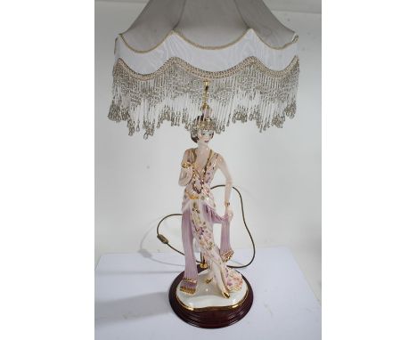 Large Italian figural table lamp, in the form of an Art Deco figurine, raised on circular wooden base. 98cm high including sh