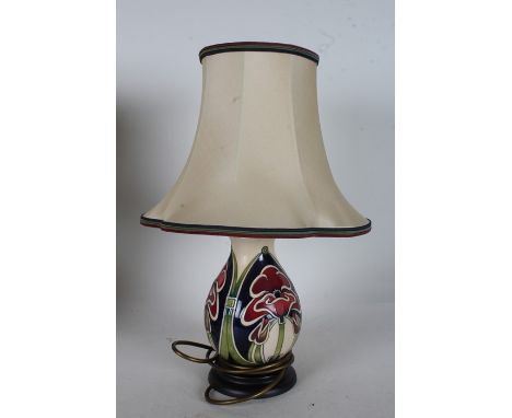 Moorcroft pottery table lamp, with stylised poppy design, raised on circular base, 22cm high excluding fitting and shade