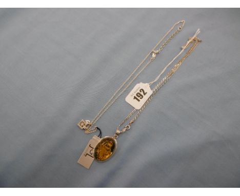 A silver and amber pendant and chain and a charm pendant silver chain
