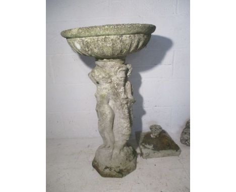 A concrete bird bath, base is in the form of semi nude females. Plus two other concrete garden ornaments.