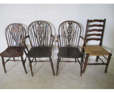 An antique Windsor chair along with two similar carvers and a rush seated ladder back chair