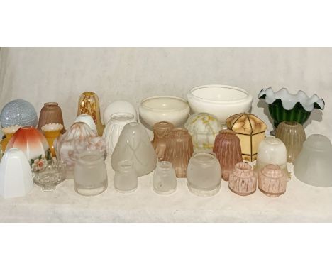 A large collection of vintage glass light shades, sconces etc