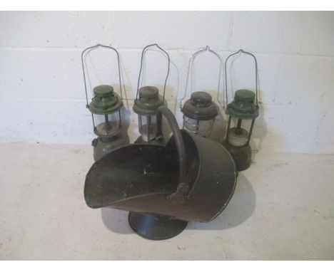 Four Tilley lamps, two with broad arrow stamp and date 1964 and 1968 respectively, plus a coal scuttle bucket.