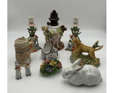 A collection of various porcelain including a German lamp base in the form of three cherubs (possibly Schierholz Plaue), a He