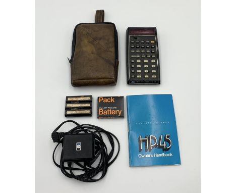 A Hewlett-Packard HP45 1970's scientific calculator with original carry case, instruction manual, charger and spare batteries
