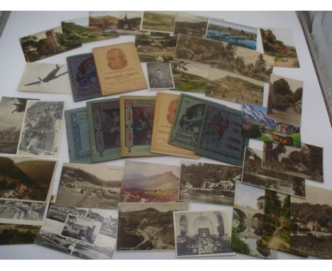 A collection of vintage postcards and Church Art Stamp Albums