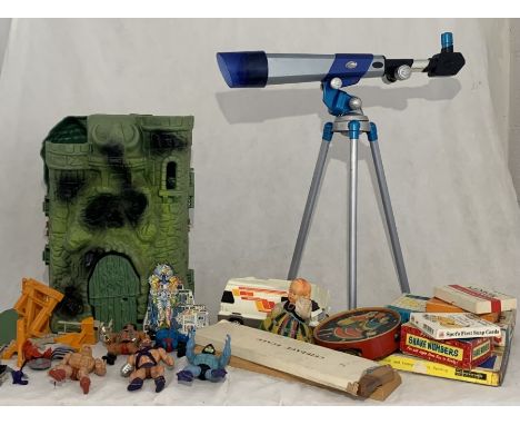 A collection of vintage toys including He-Man action figures with accessories, Castle Greyskull, Tambourine, various games et