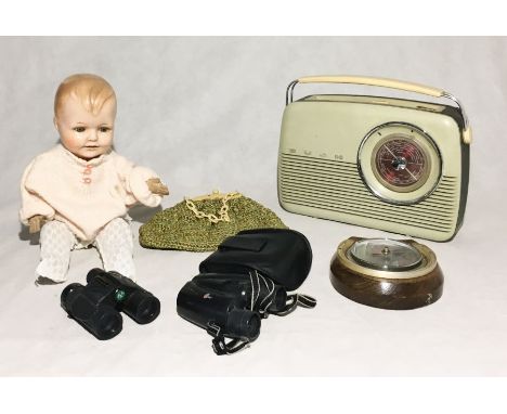 An assortment of items including a German doll, Bush TR 820 radio, barometer etc.