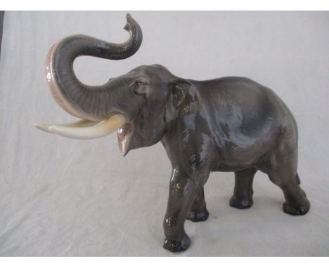 A ceramic elephant. Height 41cm. Has had a repair to one tusk. AF