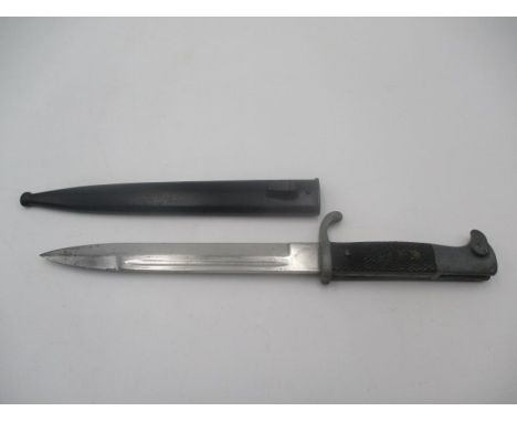 A German WWII bayonet, the steel blade stamped E u F Horster, Solingen, with eagle head handle, black plastic chequered grip 