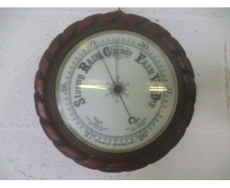 A Victorian aneroid barometer with rope twist frame