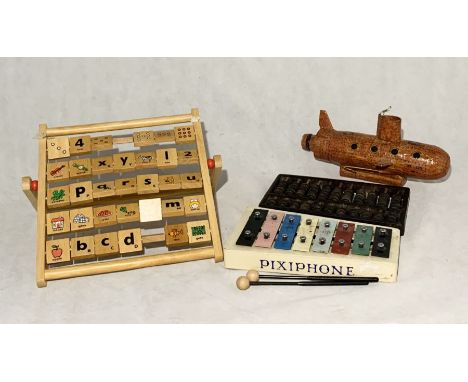 A small collection of toys including a Chinese abacus, Pixiephone glockenspiel, handmade submarine etc. 