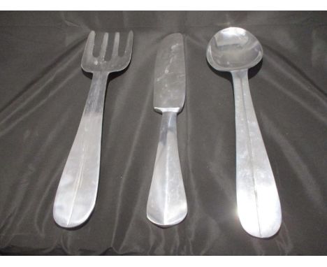 A set of metal wall hangings in the form of a oversized fork, knife and spoon - approx. 61cm in length 