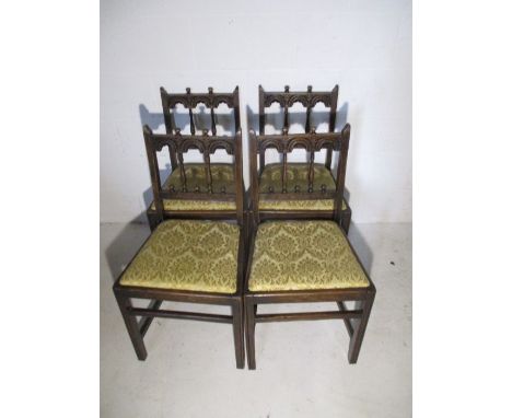 A set of four Ercol dining chairs with carved detailing 