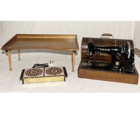 A Singer 99k sewing machine along with a vintage lap tray "The Superior", a 60's tiled warming tray and a lidded pottery urn.